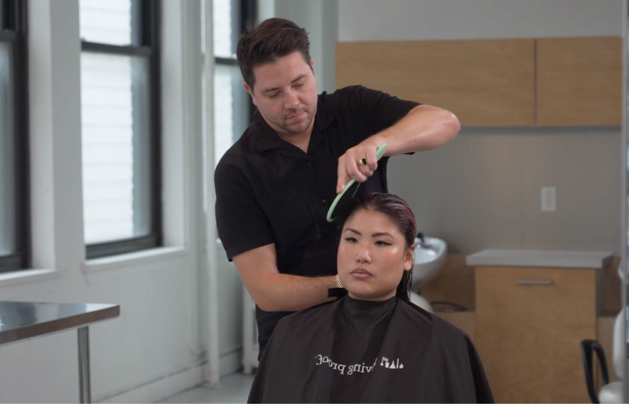 Man brushing hair in a salon.