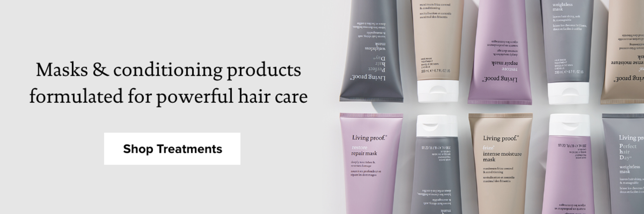 A top-down view of Living Proof’s hair treatment products, arranged in alternating colors that include grey, mauve, and sand-hued squeeze bottles.